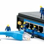 IT Solutions section - Team of miniature it technicians plugging in an Ethernet cable to into a switch.